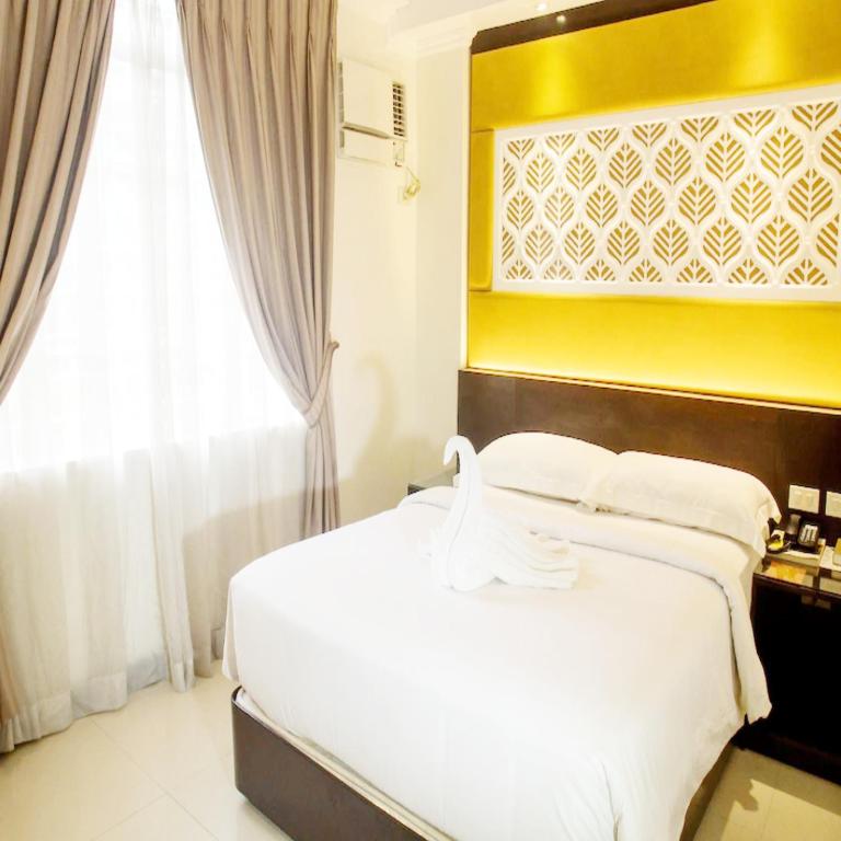 Postel nebo postele na pokoji v ubytování M Citi Suites
