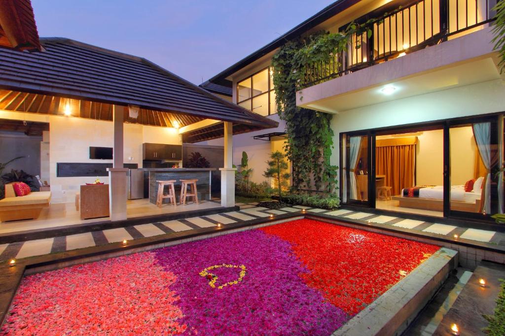 a house with a large red rug in front of it at Agata Villas Seminyak in Seminyak