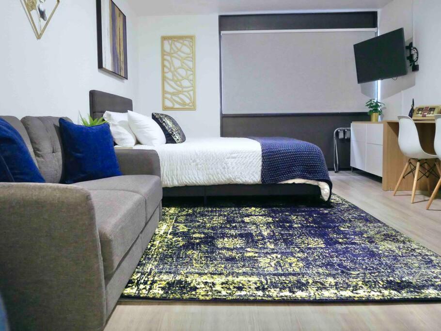 a living room with a couch and a bed at Oslo Sapphire Flat in Murray