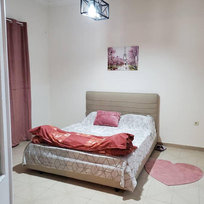 a small bed in a room with avertisement at HOME away from home_3BR at Maniatika_14min walk to the port in Piraeus