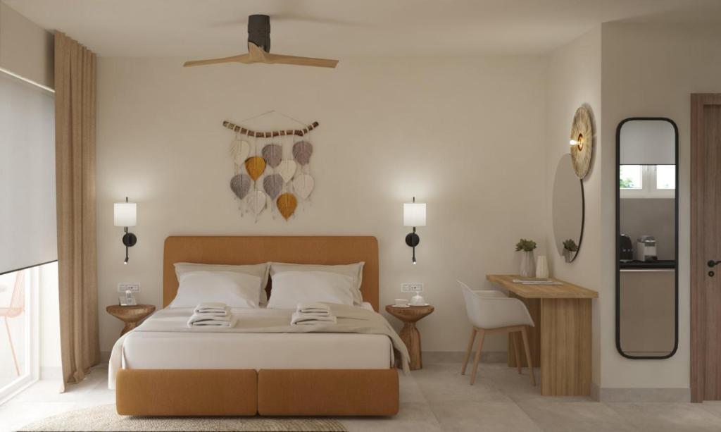 een slaapkamer met een bed, een tafel en een spiegel bij Noa Suites in Arillas