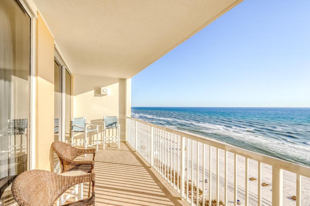 a balcony with chairs and a view of the ocean at Majestic Beach Resort Tower 2- 801 in Panama City Beach