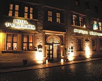 a hotel building at night with lights on a street at Romantik Hotel Tuchmacher in Görlitz