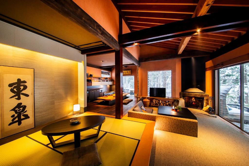a living room with a couch and a table at Sumiya Rakusuitei - Vacation STAY 16647v in Takayama