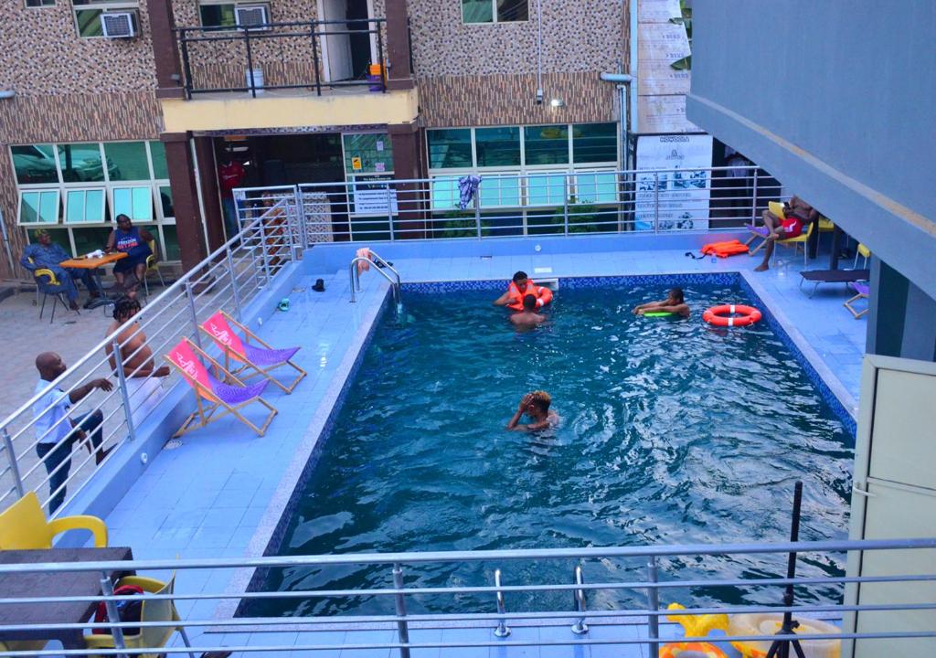 a group of people in a swimming pool at The Agore Hotels and Suites Ltd in Awoyaya