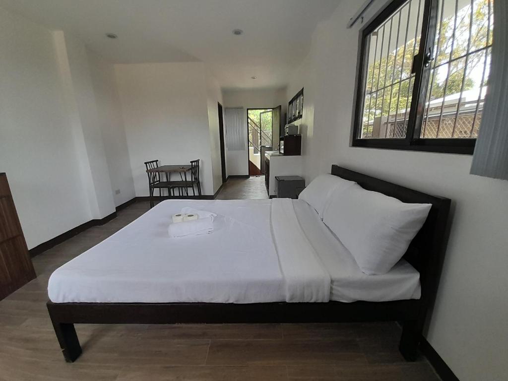 Postel nebo postele na pokoji v ubytování Palawan Residence