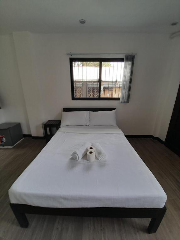 Postel nebo postele na pokoji v ubytování Palawan Residence