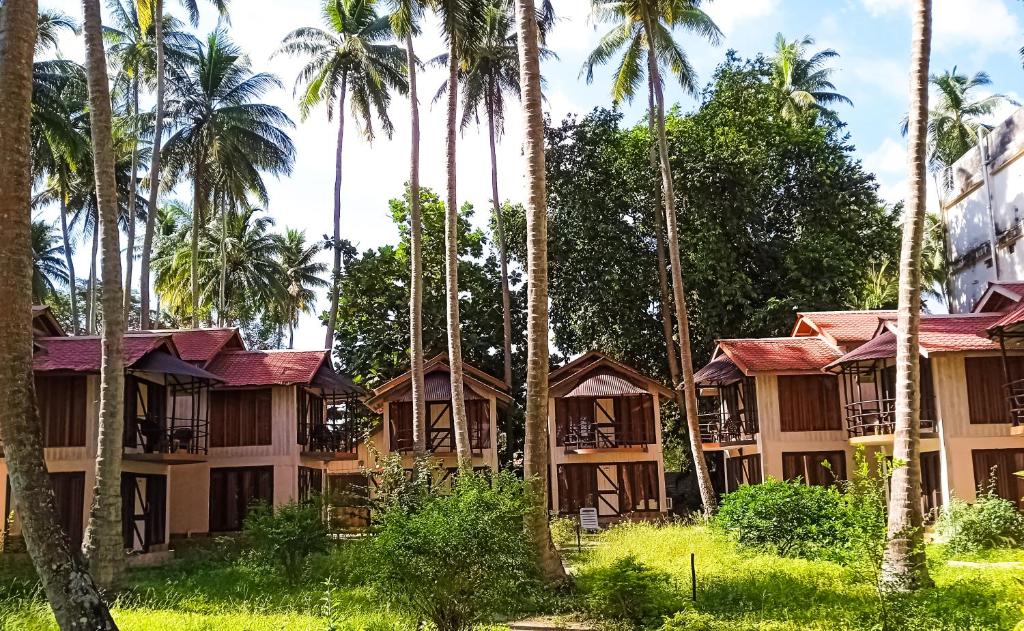 a row of palm trees in front of a resort at The Kingdom, Havelock in Havelock Island