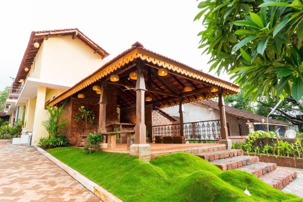 a house with a pavilion in front of it at Avontade Suites in Anjuna