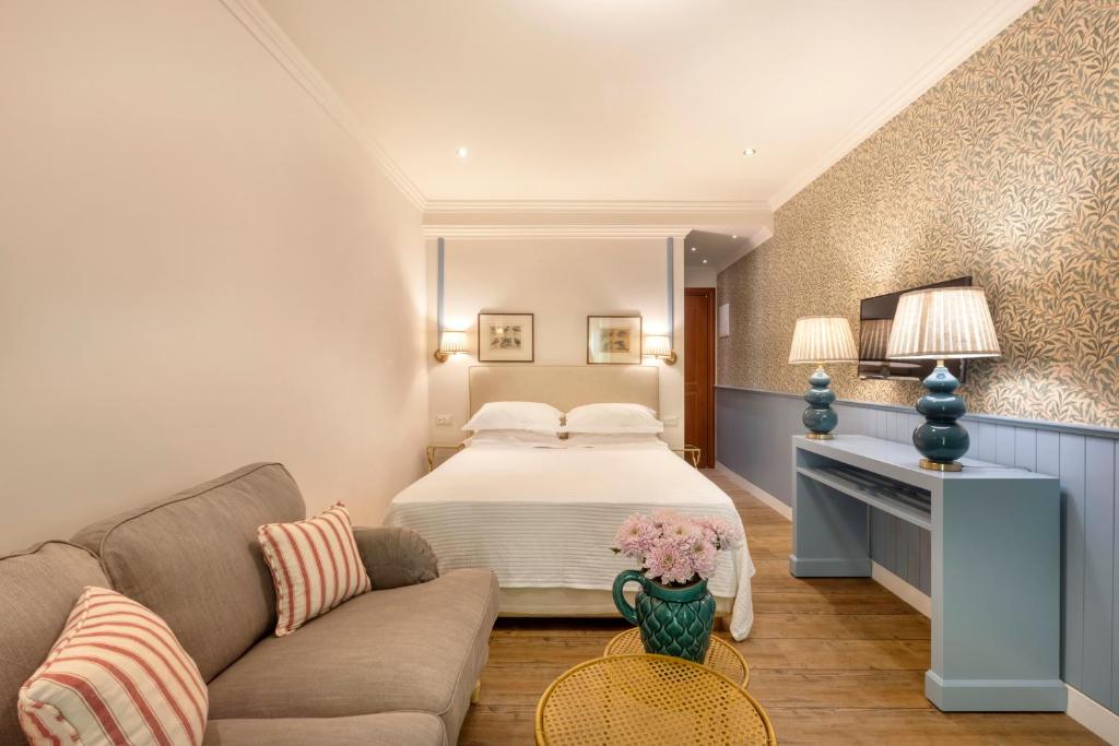 Habitación de hotel con cama y sofá en Despotiko Hotel, en Mykonos ciudad