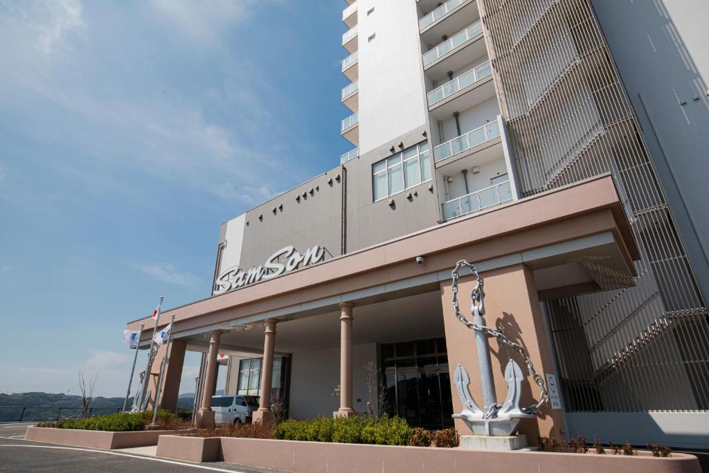a building with a sculpture in front of it at Samson Hotel in Hirado