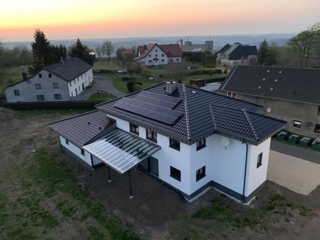 an overhead view of a house with solar panels on it at Ferienwohnung Eifelhöhe Reger in Hellenthal