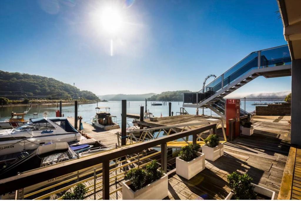 a dock with a boat on the water at Oasis on the Hawkesbury - Water Views in Brooklyn