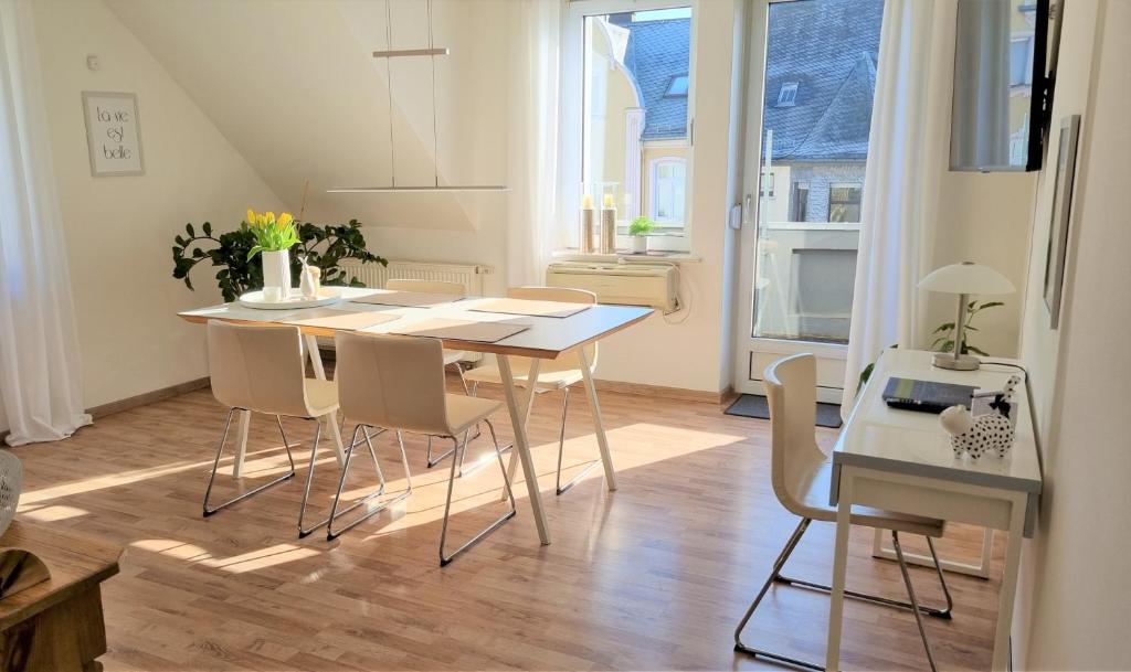 a kitchen and dining room with a table and chairs at SchönZeit in Limburg an der Lahn