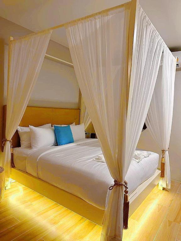 Postel nebo postele na pokoji v ubytování Chul Boutique Villa จุล บูทิค วิลล่า