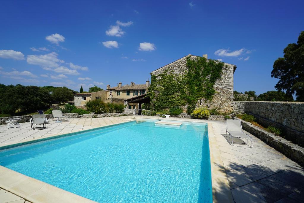 a large swimming pool in front of a building at Domaine de la Blaque - B&B in Varages