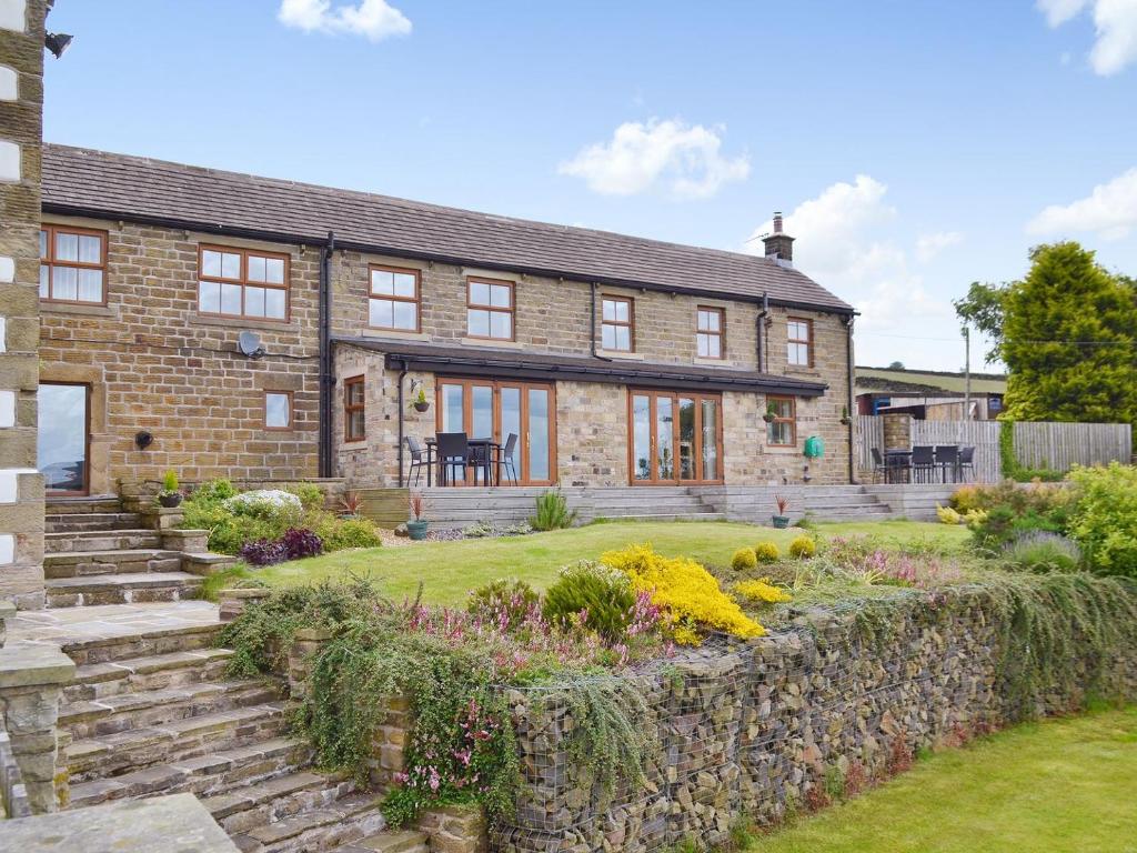 a brick house with a garden in front of it at Cote Farm in Langsett