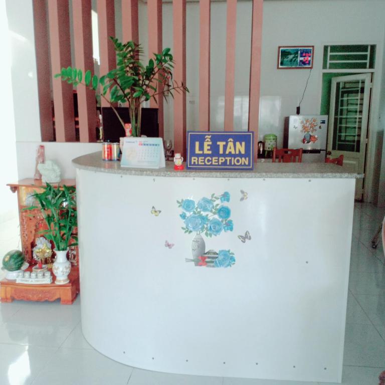 a white counter with a sign on it in a room at Nhà Nghỉ Lâm Tùng in Nha Trang