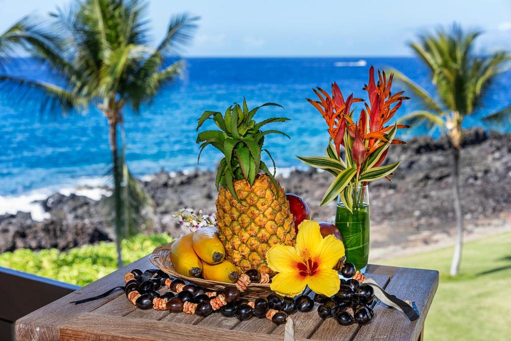 un plato de fruta en una mesa cerca de la playa en Kanaloa At Kona 1606, en Kailua-Kona