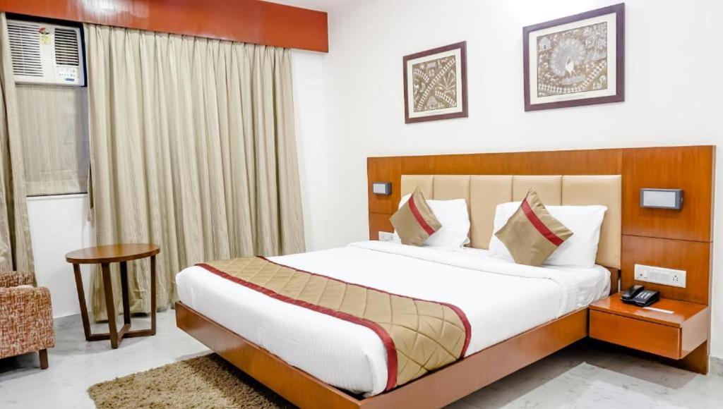 a bedroom with a large bed in a room at The Altruist Business Hotel Navi Mumbai-1 in Navi Mumbai