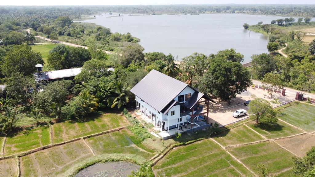 an aerial view of a house next to a lake at Relax Lake View Resort in Kataragama