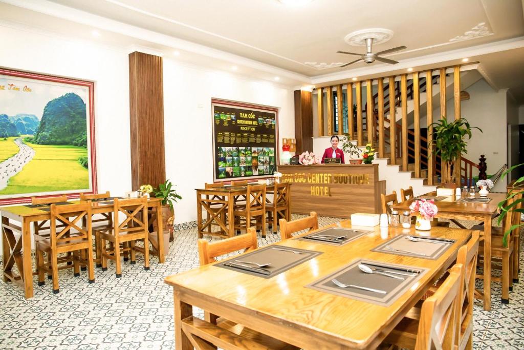 a dining room with wooden tables and wooden chairs at Tam Coc Center Boutique Hotel in Ninh Binh