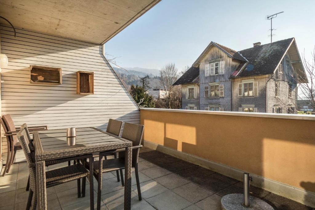 a patio with a table and chairs on a balcony at Kilian in Schwarzach