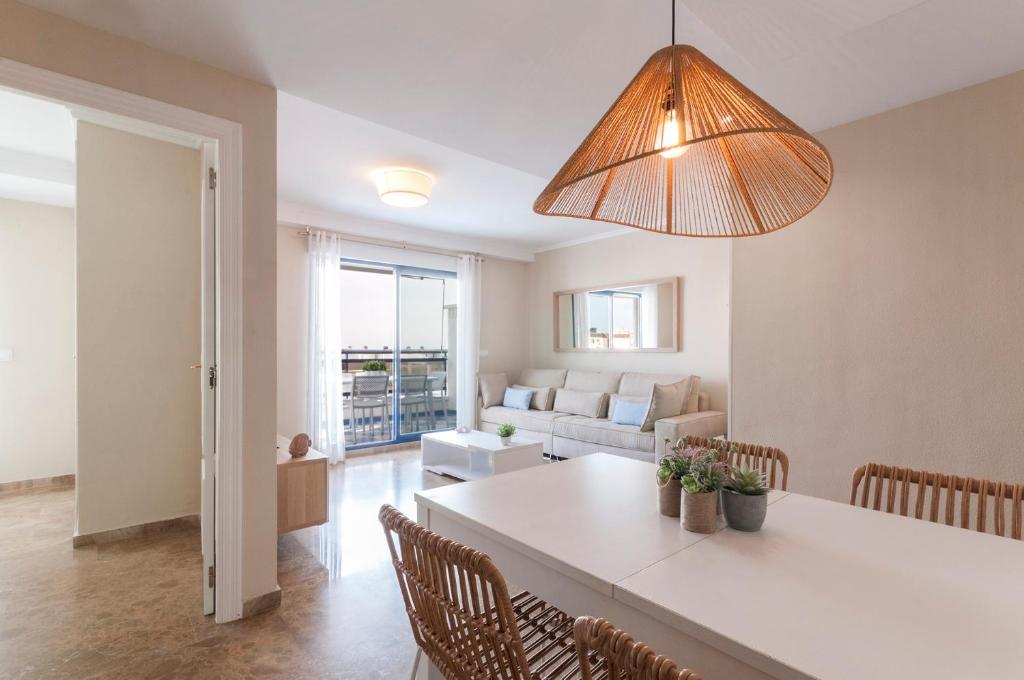 a kitchen and living room with a table and chairs at Ag Eden Resort in Gandía