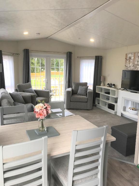 a living room with a wooden table and chairs at Cumbria Reach in Longtown