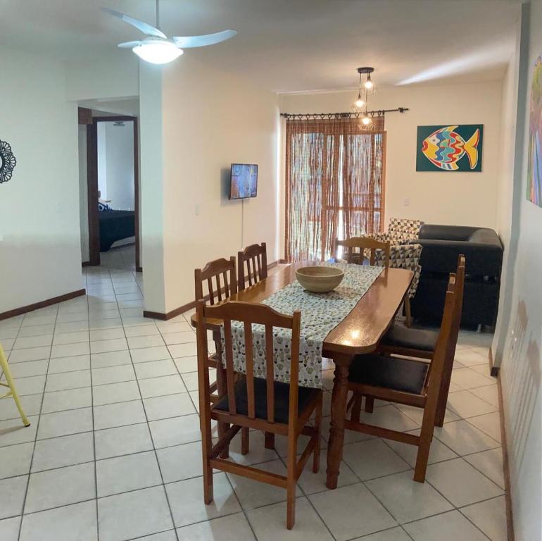 ein Esszimmer und ein Wohnzimmer mit Tisch und Stühlen in der Unterkunft Hermoso departamento en Bombas con vista al mar in Bombinhas