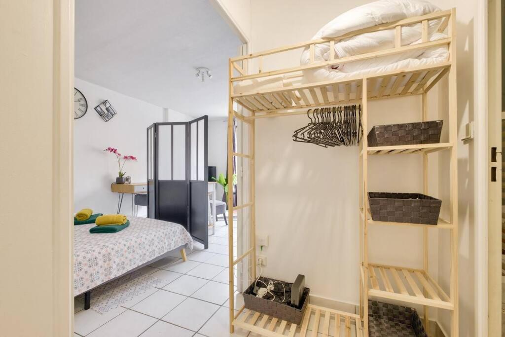 a room with two bunk beds and a bed at Studio cosy idéal pour 2 personnes situé à Lyon in Lyon