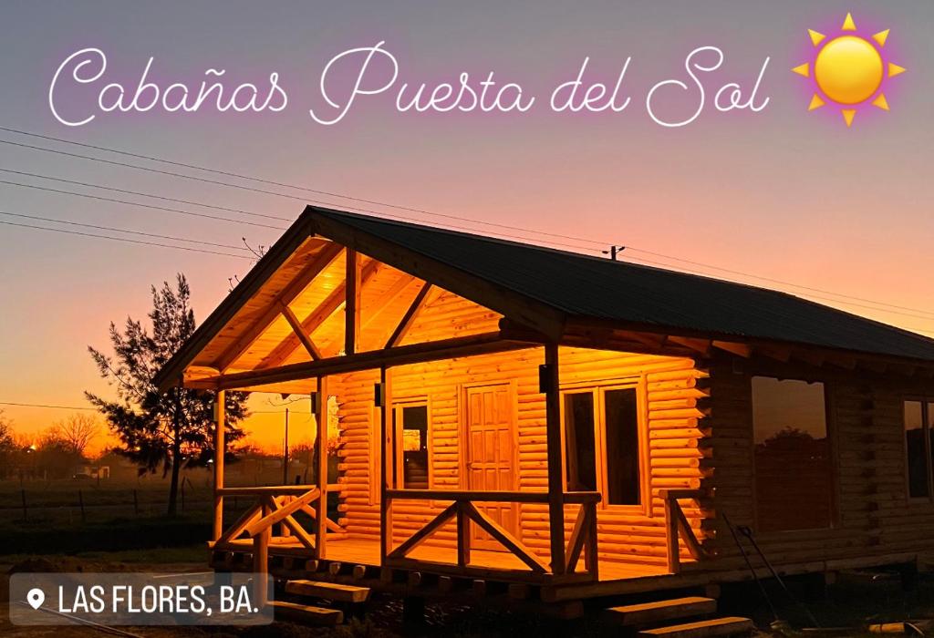 a small wooden cabin with the sunset in the background at Cabañas Puesta del Sol in Las Flores