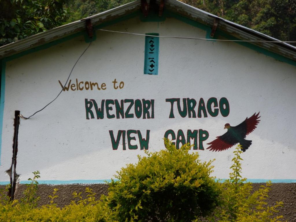 a sign on the side of a building with a turkey on it at Rwenzori Turaco View Camp in Kasese