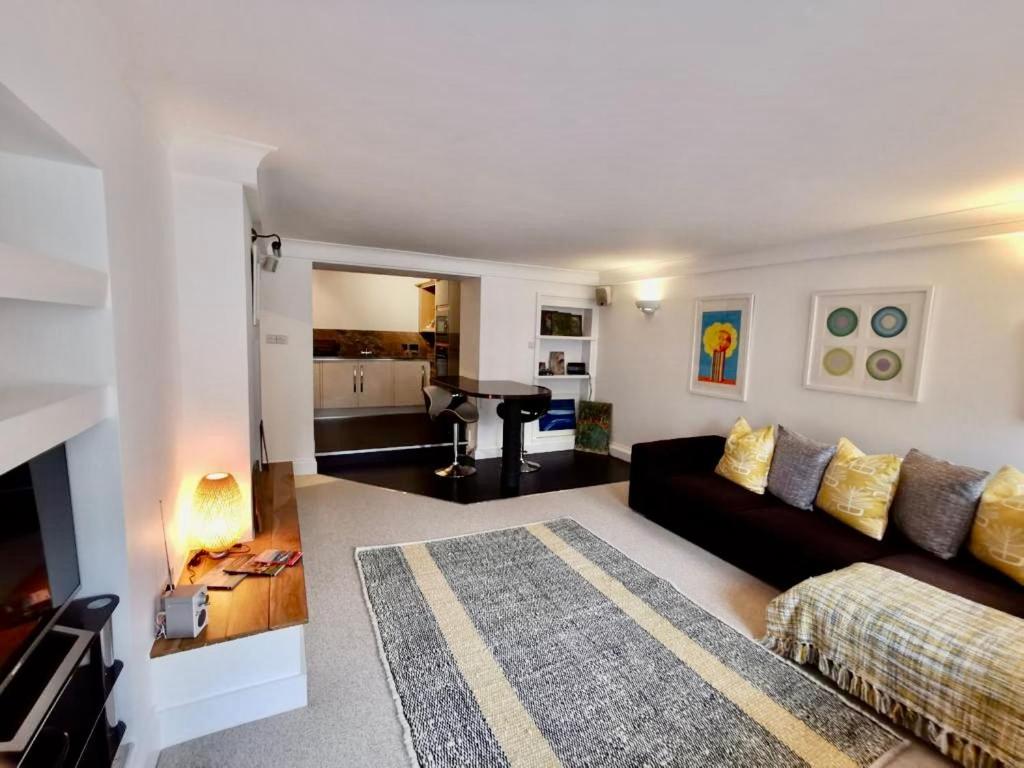 a living room with a couch and a table at Sandsifter at 4 Trencrom Court, Carbis Bay,St Ives, Cornwall in Carbis Bay