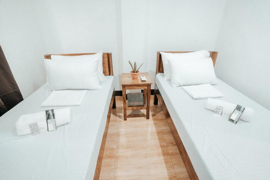 Postel nebo postele na pokoji v ubytování Sonora's Inn, Coron