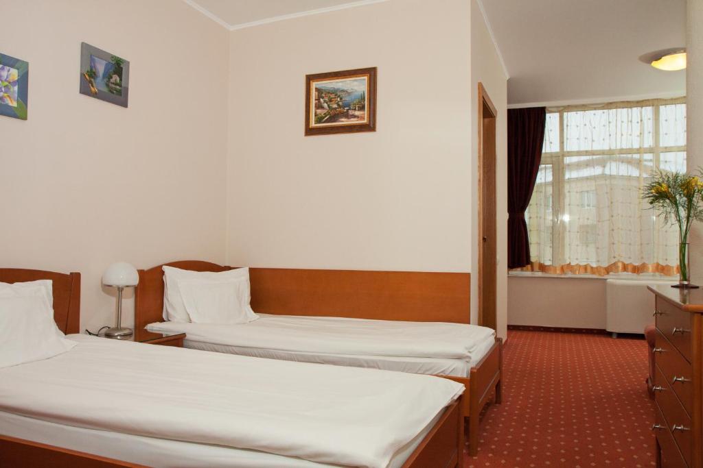 Postel nebo postele na pokoji v ubytování Hotel Hermes