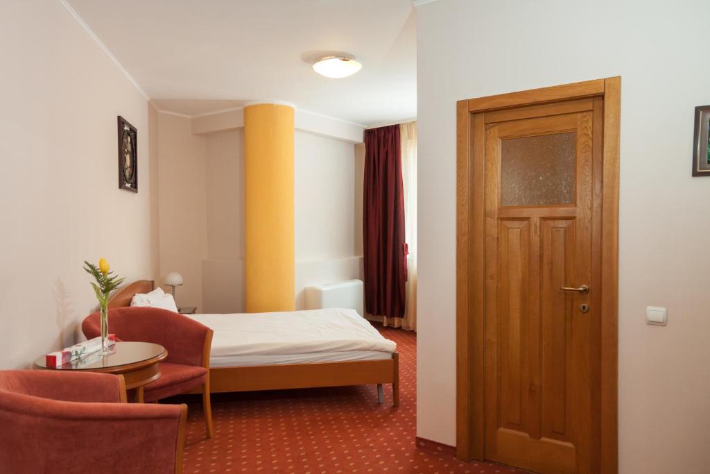 Postel nebo postele na pokoji v ubytování Hotel Hermes