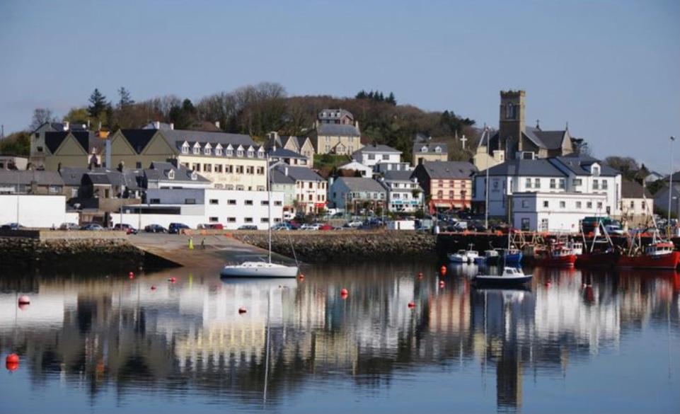 a harbor with boats in the water and a town at Harbour View Killybegs in Killybegs