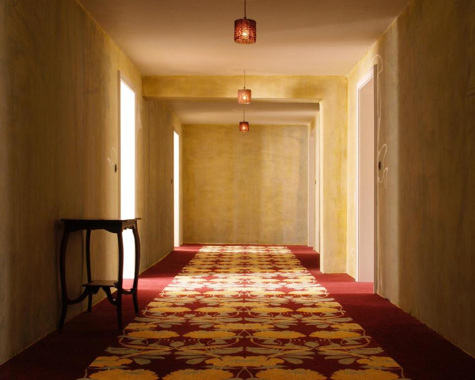 an empty hallway with a patterned carpet on the floor at Hotel Lux in Regensburg