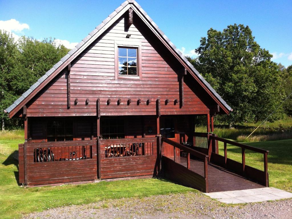 a large red barn with a gambrel at Forest Lodge Glenisle in Dalbeattie