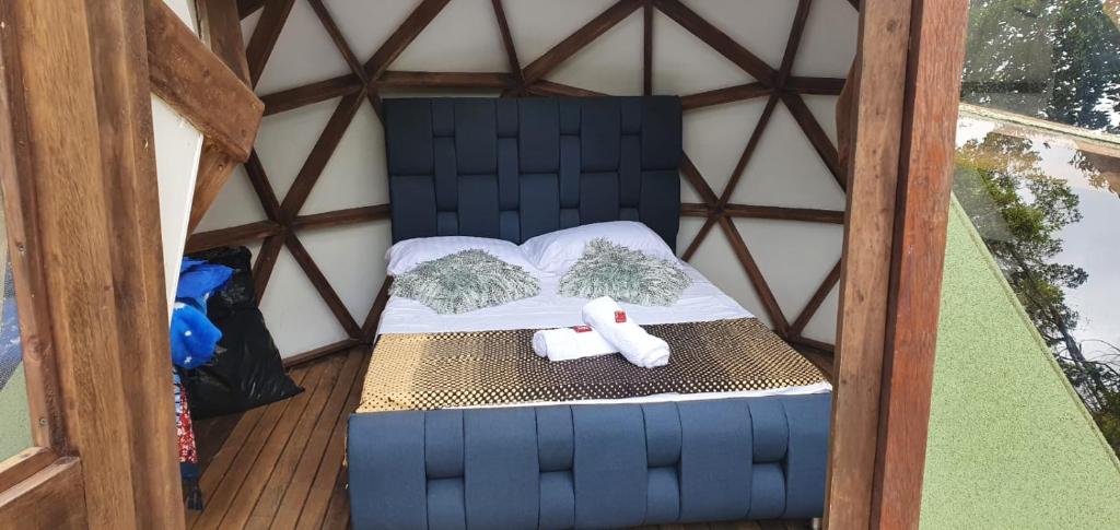 a bed in a gazebo with a book on it at Reserva Ecoturística Villa Diosa in Confines