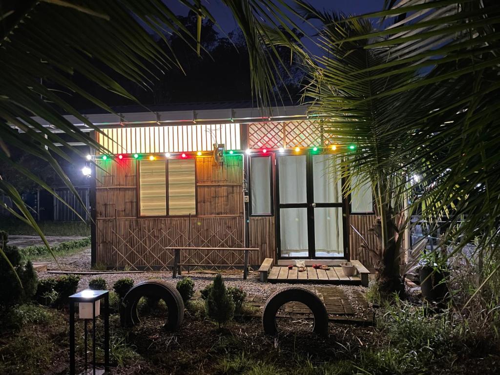 a house with christmas lights in front of it at Papadam Bamboo House in Bintulu