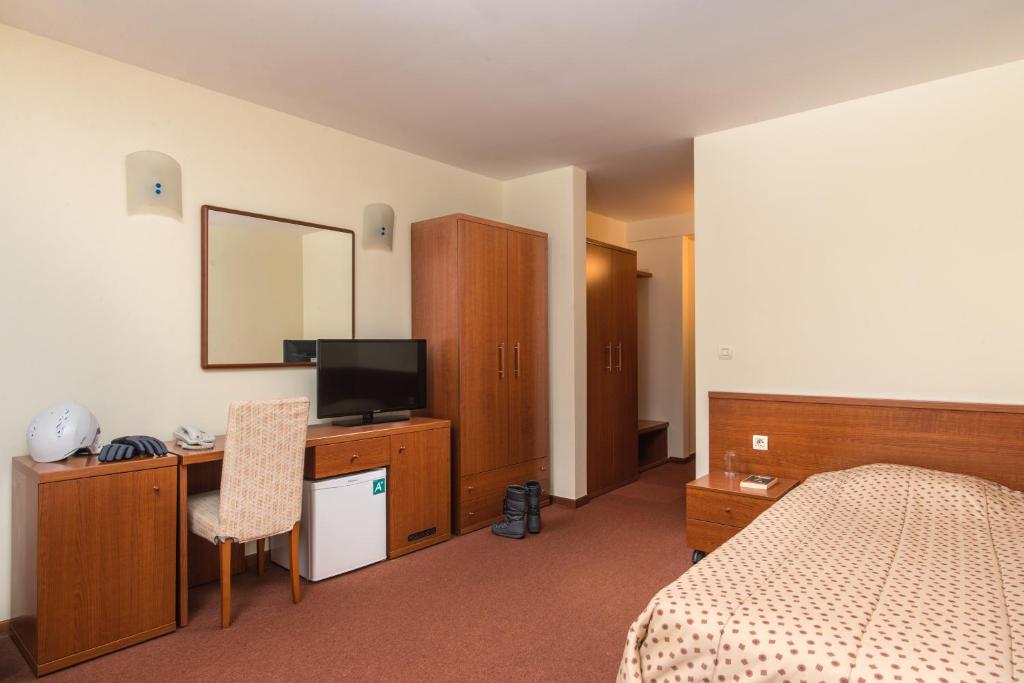 Postel nebo postele na pokoji v ubytování Hotel Pirin