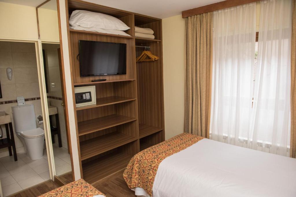 Postel nebo postele na pokoji v ubytování Del Bosque Apart Hotel
