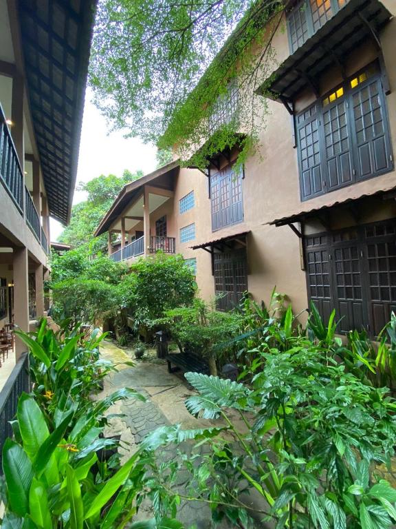a garden in front of a building with plants at Ombak Dive Resort Perhentian Island in Perhentian Islands