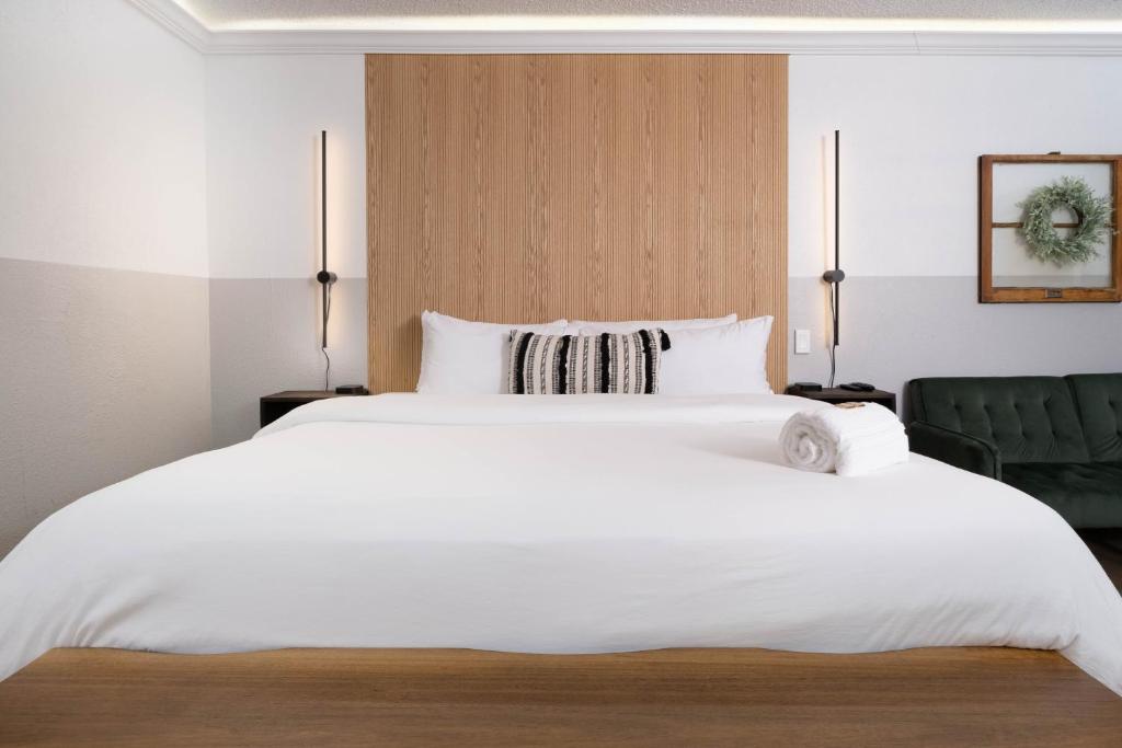 a large white bed in a hotel room at Cactus Cove Inn and Suites in Amarillo