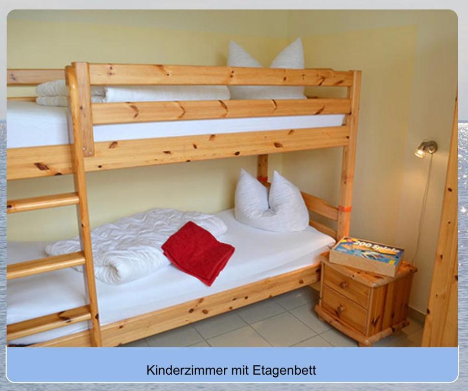 a bedroom with two bunk beds with white sheets at Am Mühlenkamp daheim 7, 8, 14 in Heringsdorf