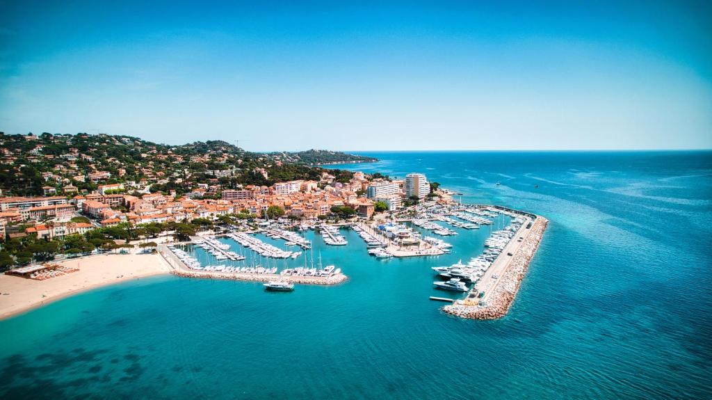 an aerial view of a harbor with boats in the water at Hotel Les Palmiers in Sainte-Maxime