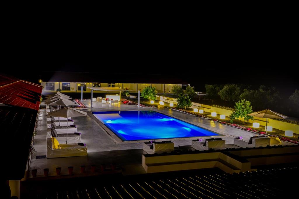 an overhead view of a swimming pool at night at Sesmarias Turismo Rural & SPA in Peroguarda