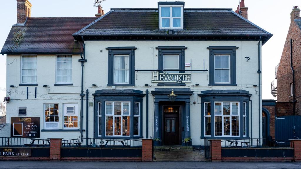 a white building with a sign on the front of it at The Heworth Inn in York